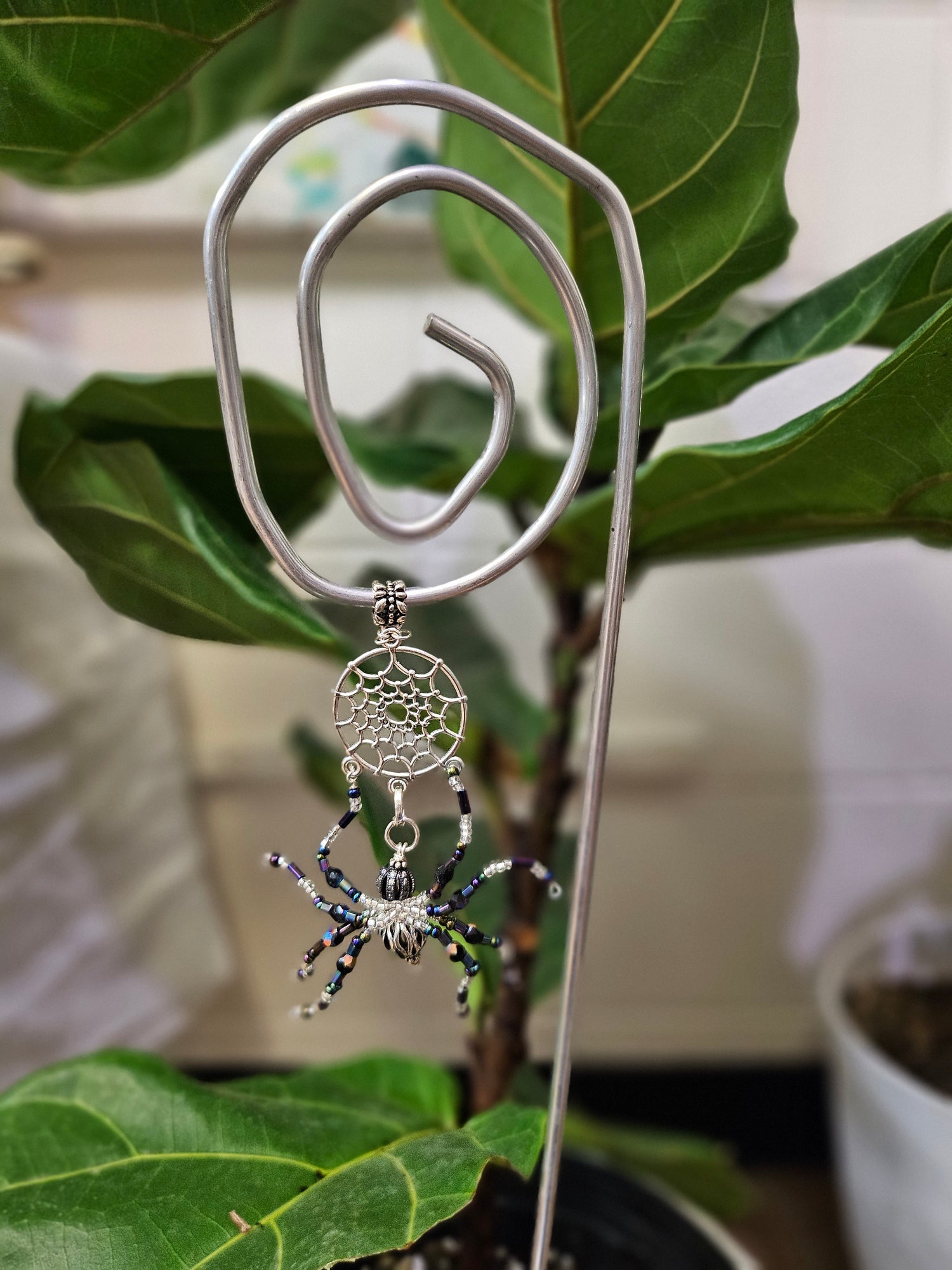 Add a touch of handcrafted magic to your plant collection with this Handmade Beaded Metal Houseplant Stake. Whether adorning a sunny windowsill, enhancing your indoor jungle, or sprucing up a patio garden, this stake offers a charming way to celebrate nature&