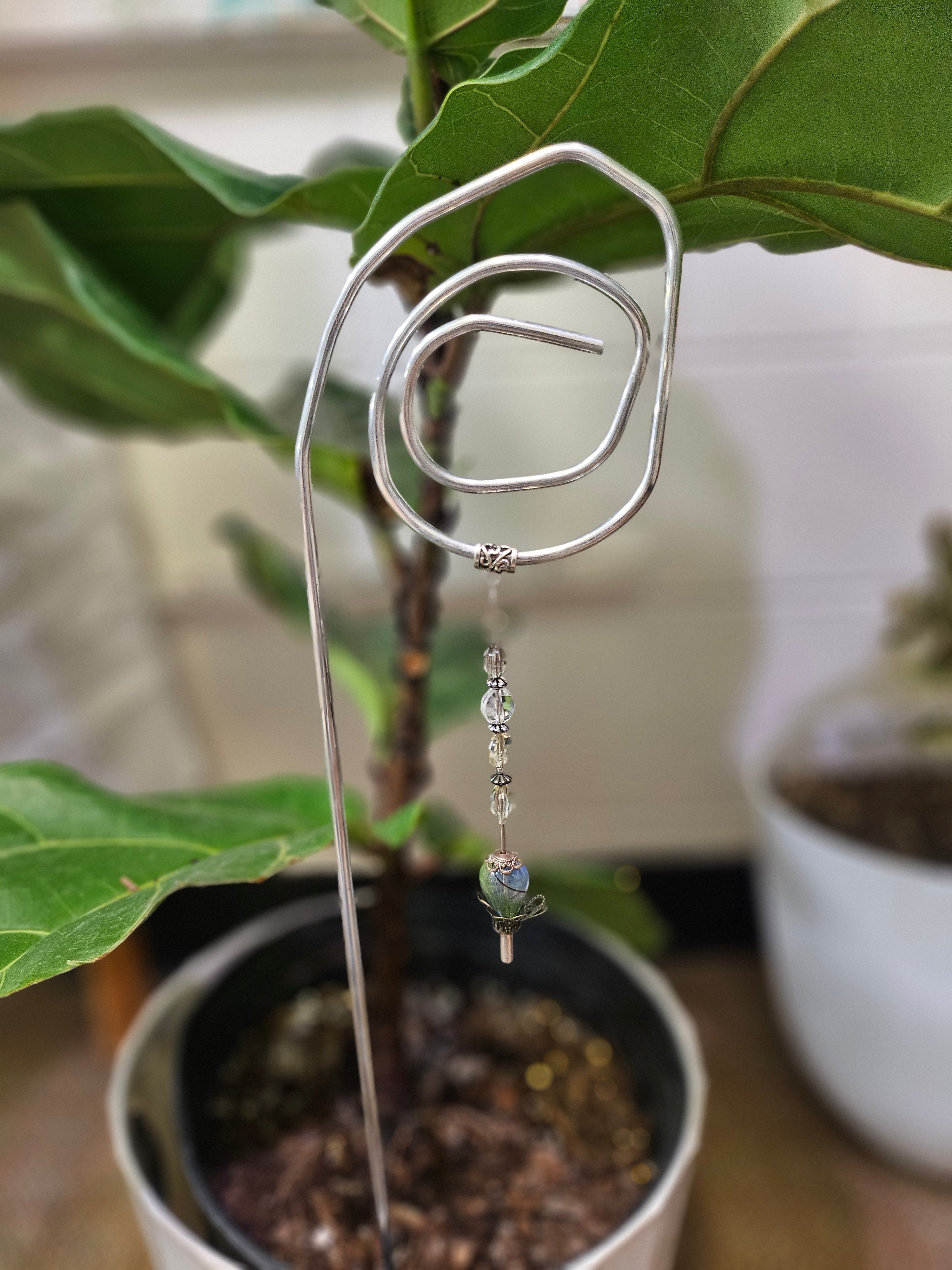 Add a touch of handcrafted magic to your plant collection with this Handmade Beaded Metal Houseplant Stake. Whether adorning a sunny windowsill, enhancing your indoor jungle, or sprucing up a patio garden, this stake offers a charming way to celebrate nature&