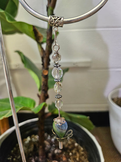 Add a touch of handcrafted magic to your plant collection with this Handmade Beaded Metal Houseplant Stake. Whether adorning a sunny windowsill, enhancing your indoor jungle, or sprucing up a patio garden, this stake offers a charming way to celebrate nature&