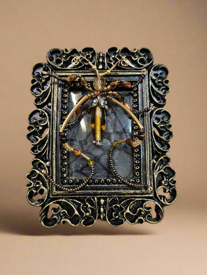 Jeweled Insect and Creature Art in Small Frame by KStonely (Kathy Epperley) is a celebration of nature’s elegance and meticulous craftsmanship. This 3D artwork captures the essence of KStonely’s artistry, merging intricate beadwork with an ethereal, whimsical touch.