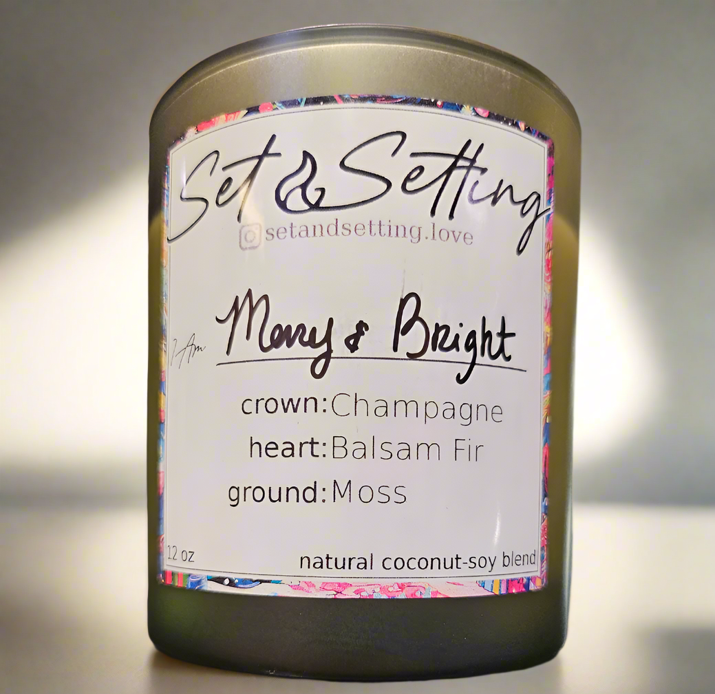 Merry and Bright 12oz Candle by Set &amp; Setting Love features a festive blend of champagne, balsam fir, and moss in an elegant evergreen glass jar. Made with a natural coconut-soy wax blend, it offers a cleaner, longer burn. Perfect for celebrations, self-care, and gifting, it adds warmth and luxury to any space.