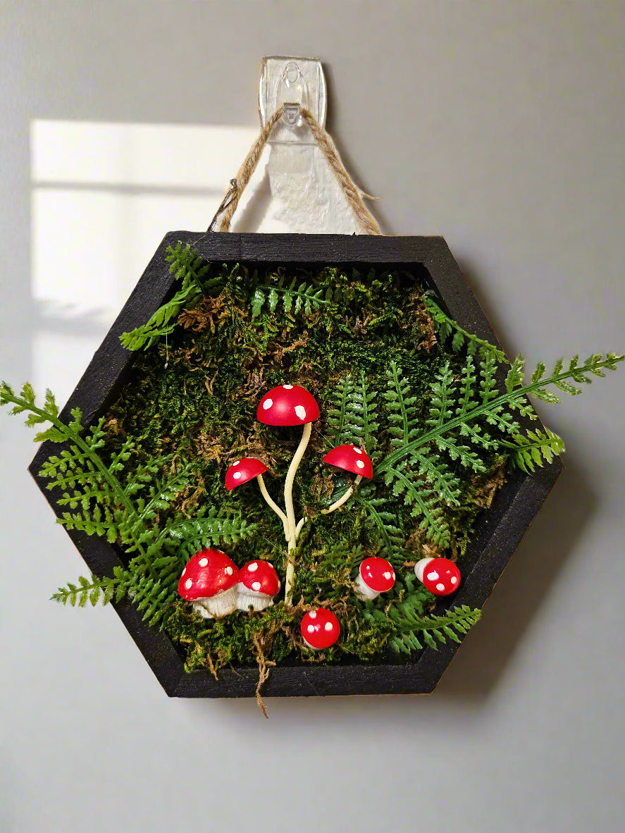 is a charming collection of four 5&quot; x 5&quot; mixed-media art pieces featuring mushrooms, gemstones, and blossoms. Blending preserved natural textures with handcrafted details, this series celebrates forest magic. Perfect for woodland-inspired décor or cozy spaces.